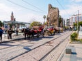 Antalya, Turkey - February 24, 2019: Row of horse-drawn carriages parked along the tram rails in downtown in Antalya