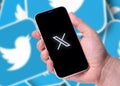 Antalya, Turkey - July 24, 2023: Twitter X logo on smartphone and Twitter logo in background