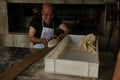 Male chef making bread dough at bakery kitchen.