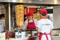 Cooking fast food with meat fried on a spit on a busy tourist st Royalty Free Stock Photo