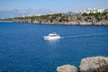 The yacht sails along the rocky coast, an excursion along the coast of Antalya Royalty Free Stock Photo