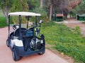 Antalya, Turkey, November 2019: a Golf Car with a bag of golf clubs on the track among the golf courses Royalty Free Stock Photo