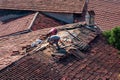 Roofers repairing the tiled roof of a historic building in KaleiÃÂ§i, Antalya