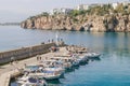 Antalya, Turkey - November 15, 2022: Small fishing boats at the harbor with a lighthouse Royalty Free Stock Photo