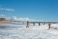 Joyful young women playing in the waves in summer in Antalya