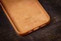 Antalya, Turkey - October 28, 2021: Newly designed Golden Brown MagSafe leather case for Apple iPhone 13 Pro on wooden background