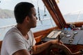 Antalya/Turkey-September 25 2020:Captain or helmsman on a yacht or motorboat cruising in Mediterranean viewed from side sitting at