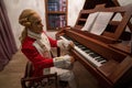 Antalya, Turkey - September 10, 2021: A composer from 17th century in rocco traditional costume playing piano Royalty Free Stock Photo