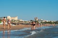 Ourists walking on the seashore, sunbathing or swimming in summer in Antalya