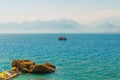 ANTALYA, TURKEY: Ship with tourists sails along the Mediterranean coast on a sunny summer day in Antalya. Royalty Free Stock Photo