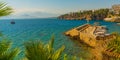 ANTALYA, TURKEY: Ship with tourists sails along the Mediterranean coast on a sunny summer day in Antalya. Royalty Free Stock Photo