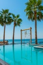 ANTALYA, TURKEY: Swimming pool and swing on the territory of Fosforlu beach on a sunny day. Royalty Free Stock Photo