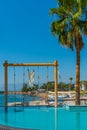 ANTALYA, TURKEY: Swimming pool and swing on the territory of Fosforlu beach on a sunny day. Royalty Free Stock Photo