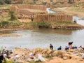 Madagascar, Antananarivo, Clay blocks at river with washing women,