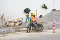 Antananarivo, Madagascar - April 24, 2019: Group of unknown Malagasy workers in hard hats and reflective jackets standing near