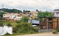 Antananarivo, Madagascar - April 24, 2019: Houses in Antananarivo suburb, small lake - rice fields - near, warehouse with wooden