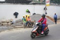 Antananarivo, Madagascar - April 24, 2019: Unknown Malagasy workers in hard hats and reflective jackets standing near gravel heap