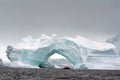 Antarctic cruise launch by an arched iceberg Antarctica Royalty Free Stock Photo