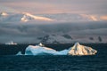 Antarctic Iceberg nature landscape during midnight sun sunset sunrise in the horizon. Early morning summer alpenglow Royalty Free Stock Photo