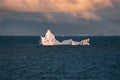 Antarctic Iceberg nature landscape during midnight sun sunset sunrise in the horizon. Early morning summer alpenglow