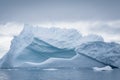 Antarctic icebergs and majestic landscape, cloudy blue sky