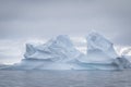 Antarctic icebergs and majestic landscape, cloudy blue sky