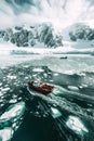 Antarctic krill fishing techniques: Fishermen on boat in icy waters, employing traditional methods to sustainably harvest krill.