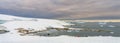 Antarctic tourists in red parkas climb an Antarctic iceberg landscape at Portal Point Antarktika