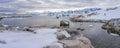 Antarctic tourists in red parkas in front of Antarctic iceberg landscape at Portal Point