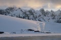 Antarctica calm pink midnight sunset over jagged mountains