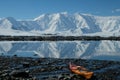 Antarctica orange kayak in a mirror blue bay