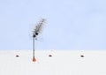 Antena on roof covered with snow