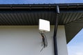 Antenna amplifier for mobile internet at home, mounted on the facade of the house outside. Royalty Free Stock Photo