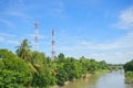 Antenna cellular tower in forest beside river and blue sky