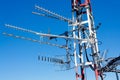 Antenna repeater messy mast in blue sky Royalty Free Stock Photo