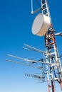 Antenna repeater messy mast in blue sky Royalty Free Stock Photo