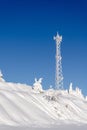 Antenna telecommunications tower covered in white frost