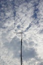 An antenna tower made of bamboo sticks and very high is located on the roof of the house with a view of the bright blue sky Royalty Free Stock Photo