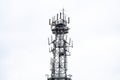 Top of Antenna used for mobile phones against grey sky, almost isolated. Royalty Free Stock Photo
