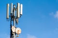 Antennas on a metal pole under a blue sky Royalty Free Stock Photo