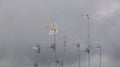 Antennas over the roofs against grey sky Royalty Free Stock Photo