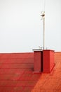 Antenne on red roof house white sky Royalty Free Stock Photo
