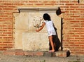 Girl at drinking fountain, Antequera, Spain.