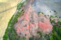 Anthropogenic terrain. The border of the wheat field runs along a cascade of waste piles formed as a result of coal mining. Shooti Royalty Free Stock Photo