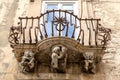 Anthropomorphic Stone figures under the balcony of La Rocca palace .Ragusa Ibla Sicily Italy