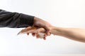 Anti-Bribery. A male`s hand in a black shirt grabs a female`s hand with a stack of money. Side view. White background. The conce