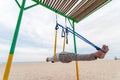 Anti-gravity Yoga, man doing yoga exercises or fly-yoga on the sea background Royalty Free Stock Photo