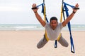 Anti-gravity Yoga, man doing yoga exercises on the sea background Royalty Free Stock Photo