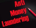 Anti Money Laundering words on black and red pencil besides. AML social govermental and business concept Royalty Free Stock Photo