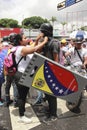 Anti Nicolas Maduro protesters wearing tear-gas mask during mass demonstrations that turned into riots in Caracas, Venezuela.